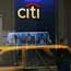 Taxi and pedestrian reflected in Citibank window