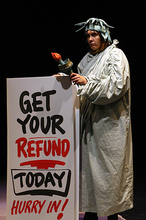 Photo: #An actor portrays a sign holder dressed as the Statue of Liberty in 