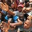 Port-au-Prince residents reach out for food.