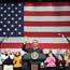 President Obama waves during a town hall meeting