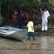 Guarani people walk around their island village 