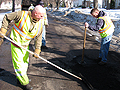 A lute and a tamper at work on potholes