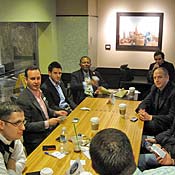 Ford Motor Co.'s Scott Monty, at left in pink shirt, hosts a "tweetup" at a Starbucks inside the Empire State Building.