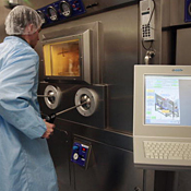 Hospital technician works by computer station 