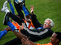 Stretching with his players