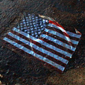 An American flag lays in a BP oil spill 