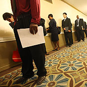 Job seekers line up to attend a job fair 
