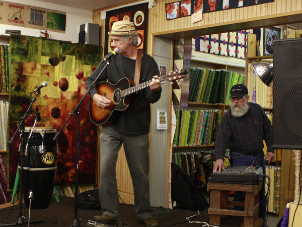 Pete Heitzman stands on a cutting table-turned-stage during a sound check at Aunt Annie's Quilts & Silks shop in Avon, Minn., on Sunday, Oct. 17, 2010. The legs of the table have hinges so that the table easily folds into a stage. Pete Heitzman stands on a cutting table-turned-stage during a sound check at Aunt Annie's Quilts & Silks shop in Avon, Minn., on Sunday, Oct. 17, 2010. The legs of the table have hinges so that the table easily folds into a stage.