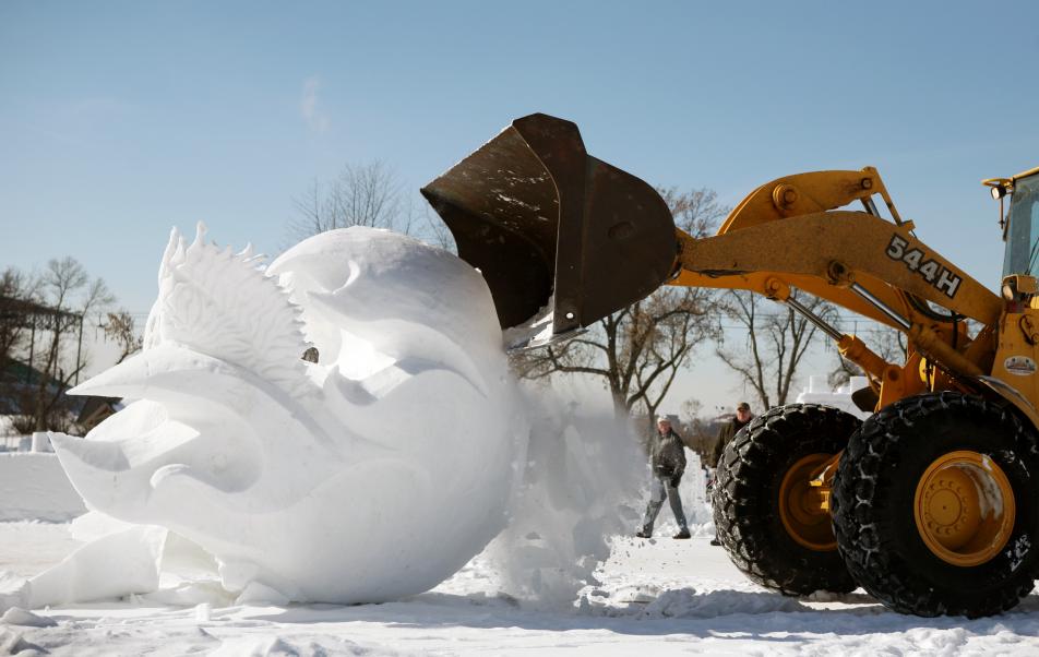 Snow sculptures topple 1 St Paul MN USA A front end loader toppled a 