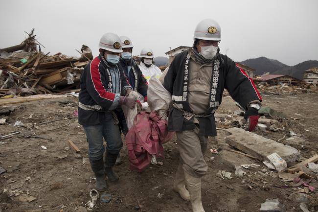 Japanese rescue workers carry