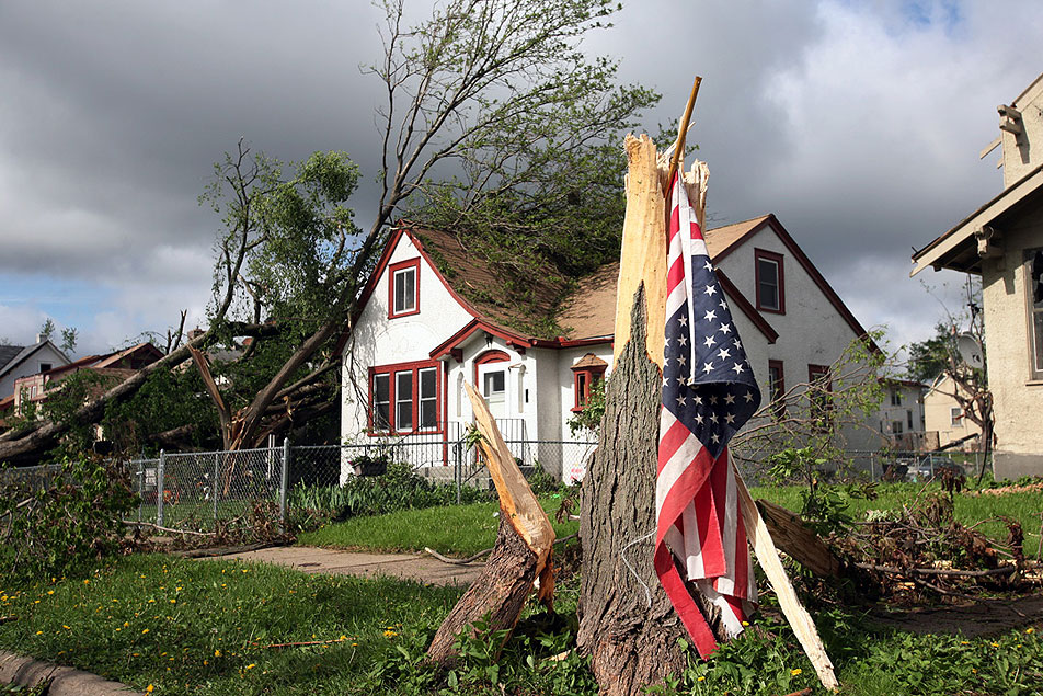 A flag hangs on a torn tree