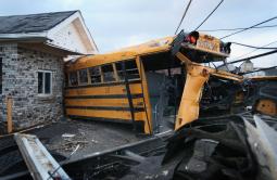 A school bus is lodged in a home