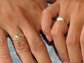 A couple holds hands showing their weddi