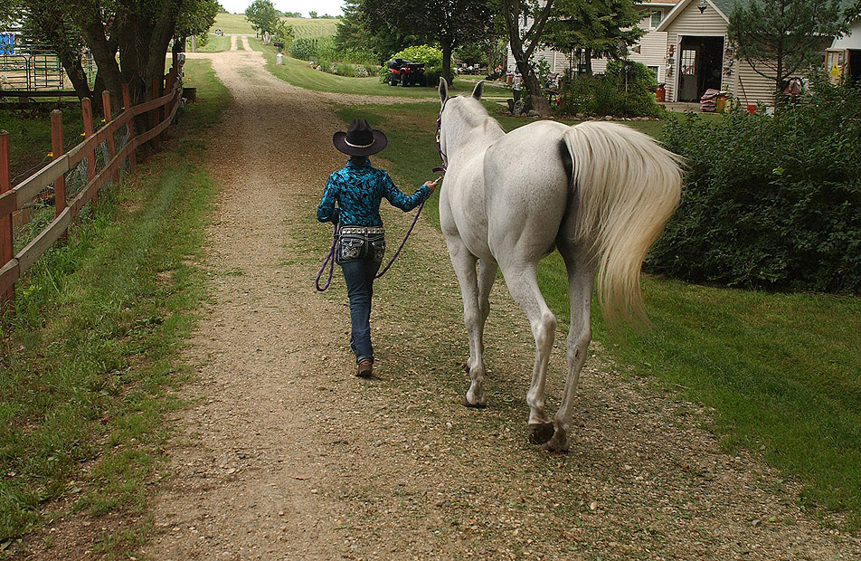 Walking her horse