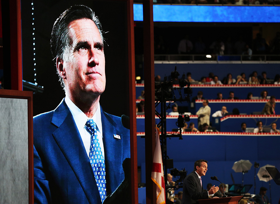 Dwarfed by an image of Romney