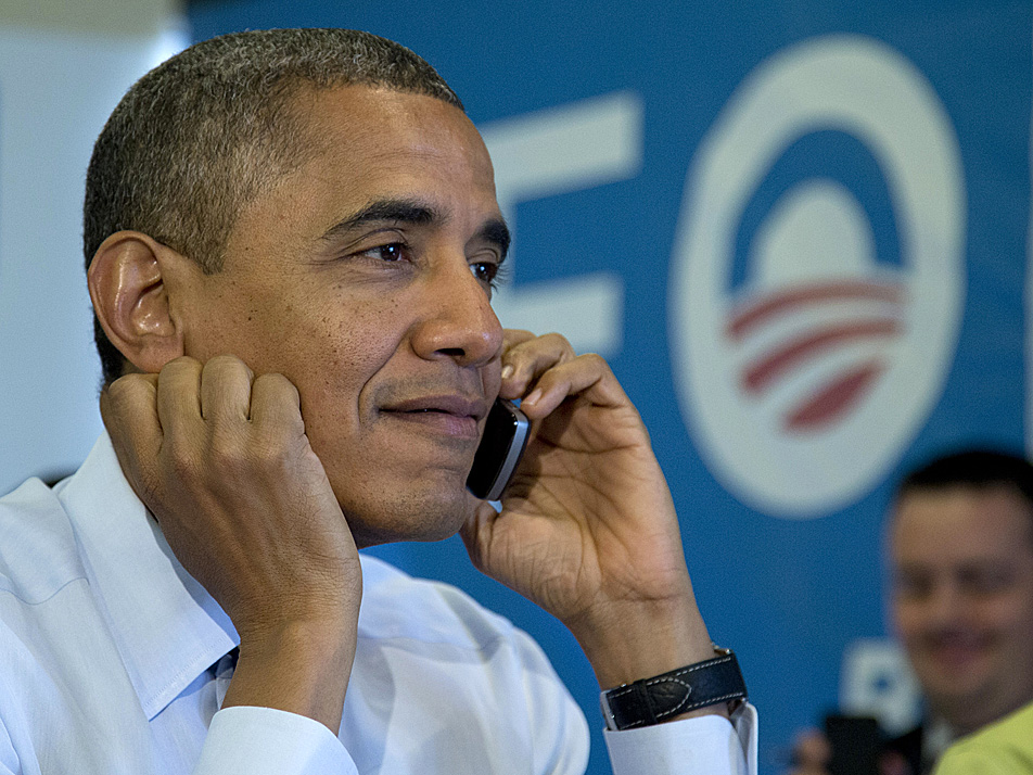 President Barack Obama calls Wisconsin volunteers as he visits a campaign office call center the morning of the 2012 election, Tuesday, Nov. 6, 2012, in Chicago.