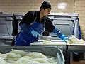 Pieces of lutefisk are cut and weighed