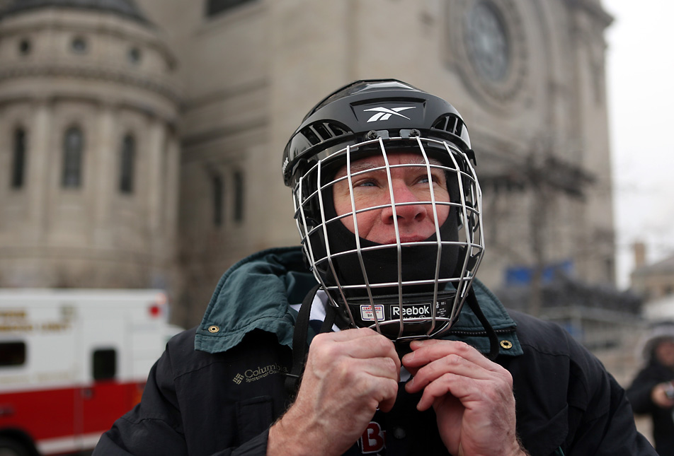 Adjusting his helmet
