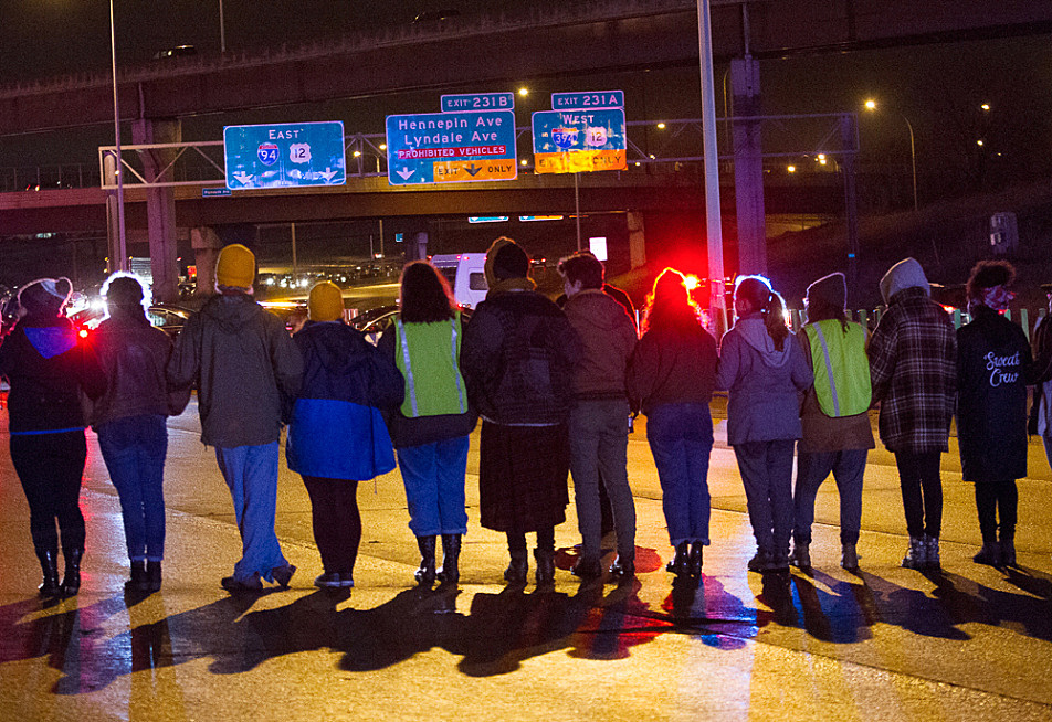 Protesters from Black Lives Matter stood in unison to block Interstate 94 westbound Monday night, Nov. 16, 2015. Many were arrested when they refused police orders to vacate the freeway.