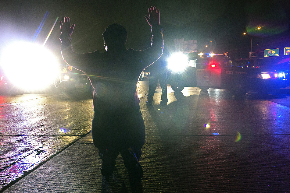 A lone protester knelt down in the middle of Interstate 94 westbound as police began to gather in response to Monday night's events.
