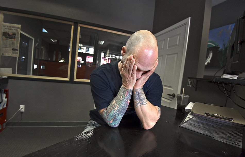 "Surviving every day in prison... It's really hard to talk about," says Michael Hansen at his tattoo shop in Northfield.
